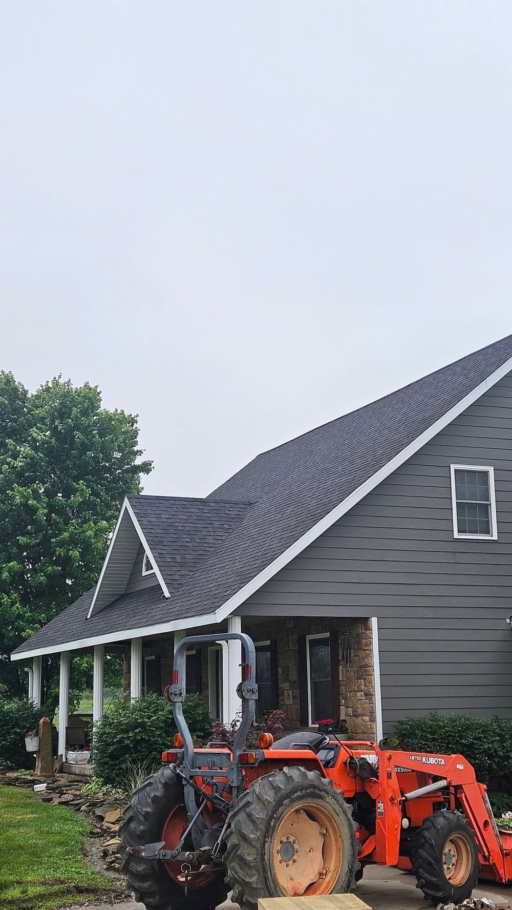 Two-story home with a dark roof, gray lap siding and crisp white fascia trim